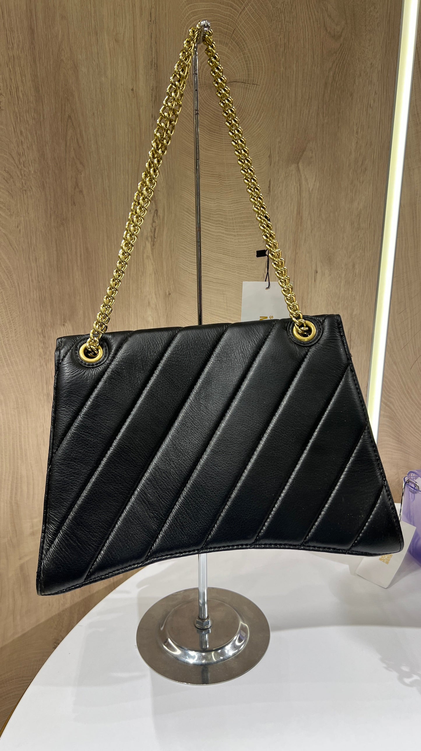 Balenciaga Crush quilted shoulder bag is crafted from black leather and features a signature gold-tone B-shaped plaque