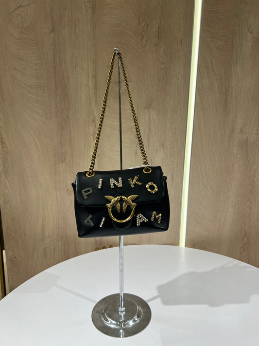 Black Pinko Mini Love Puff Logo handbag featuring prominent rhinestone lettering and a signature gold-toned bird buckle.