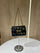 Black Pinko Mini Love Puff Logo handbag featuring prominent rhinestone lettering and a signature gold-toned bird buckle.