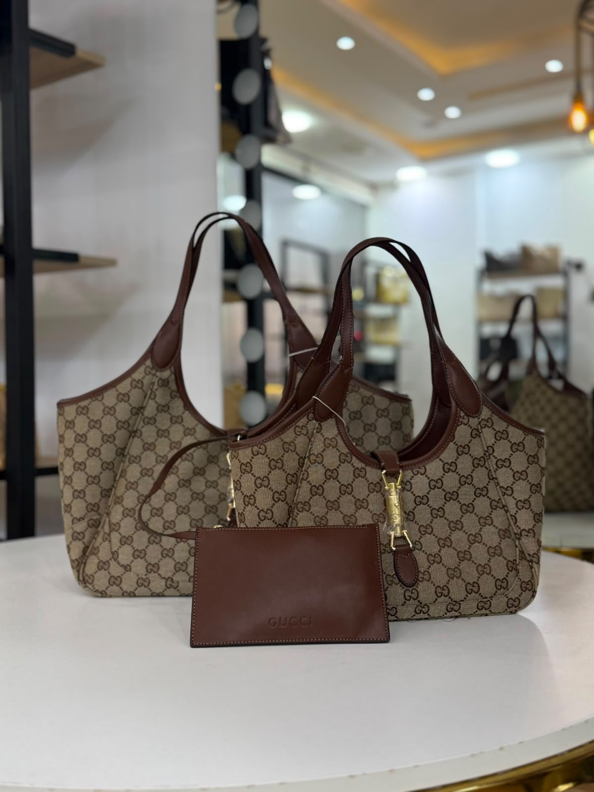 Gucci Mercato tote bag features signature GG canvas and a golden piston closure