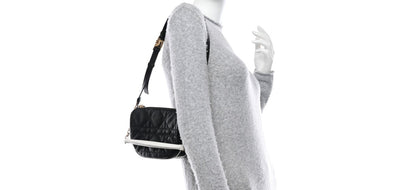 Christian Dior Vibe bag features black cannage quilted lambskin leather with a distinct half-moon shape