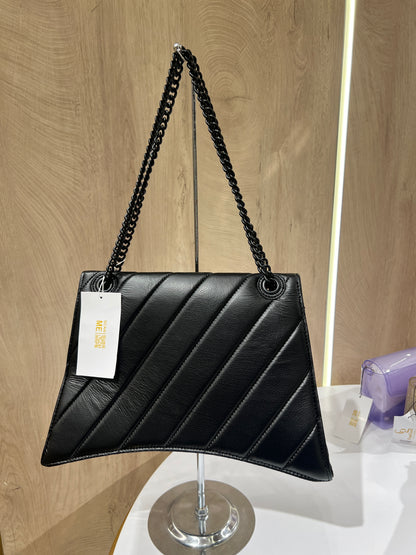 Balenciaga Crush quilted shoulder bag is crafted from black leather and features a signature black-tone B-shaped plaque