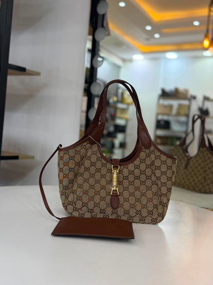 Gucci Mercato tote bag features signature GG canvas and a golden piston closure