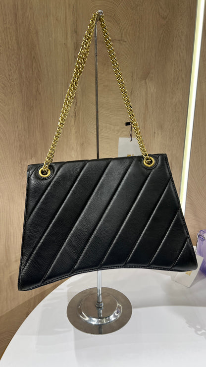 Balenciaga Crush quilted shoulder bag is crafted from black leather and features a signature gold-tone B-shaped plaque