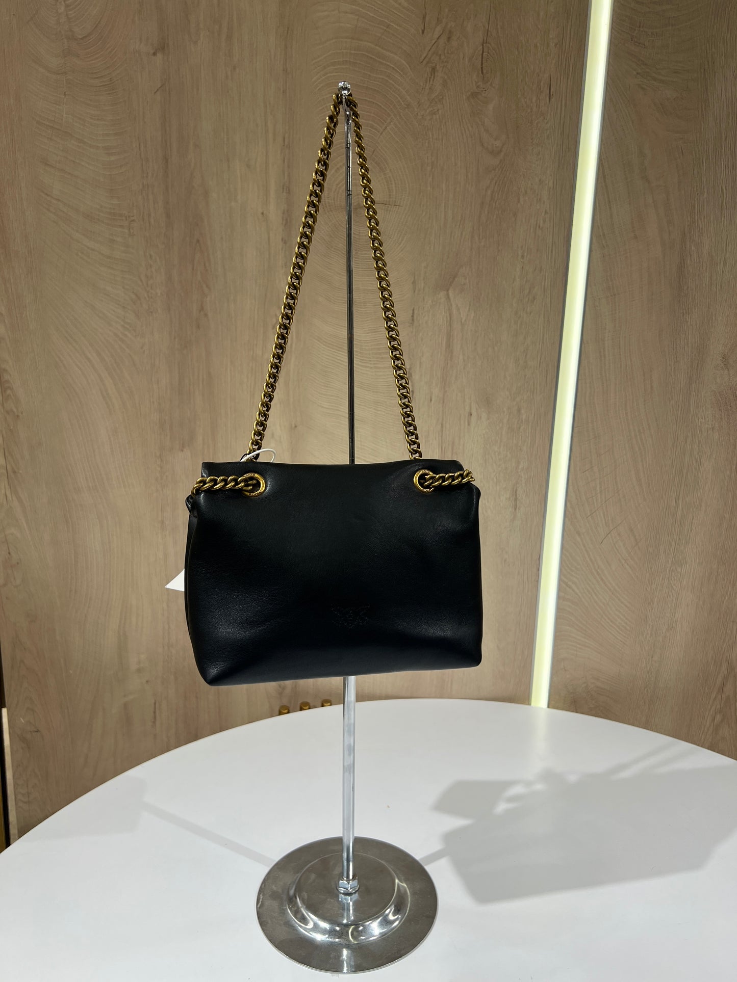 Black Pinko Mini Love Puff Logo handbag featuring prominent rhinestone lettering and a signature gold-toned bird buckle.