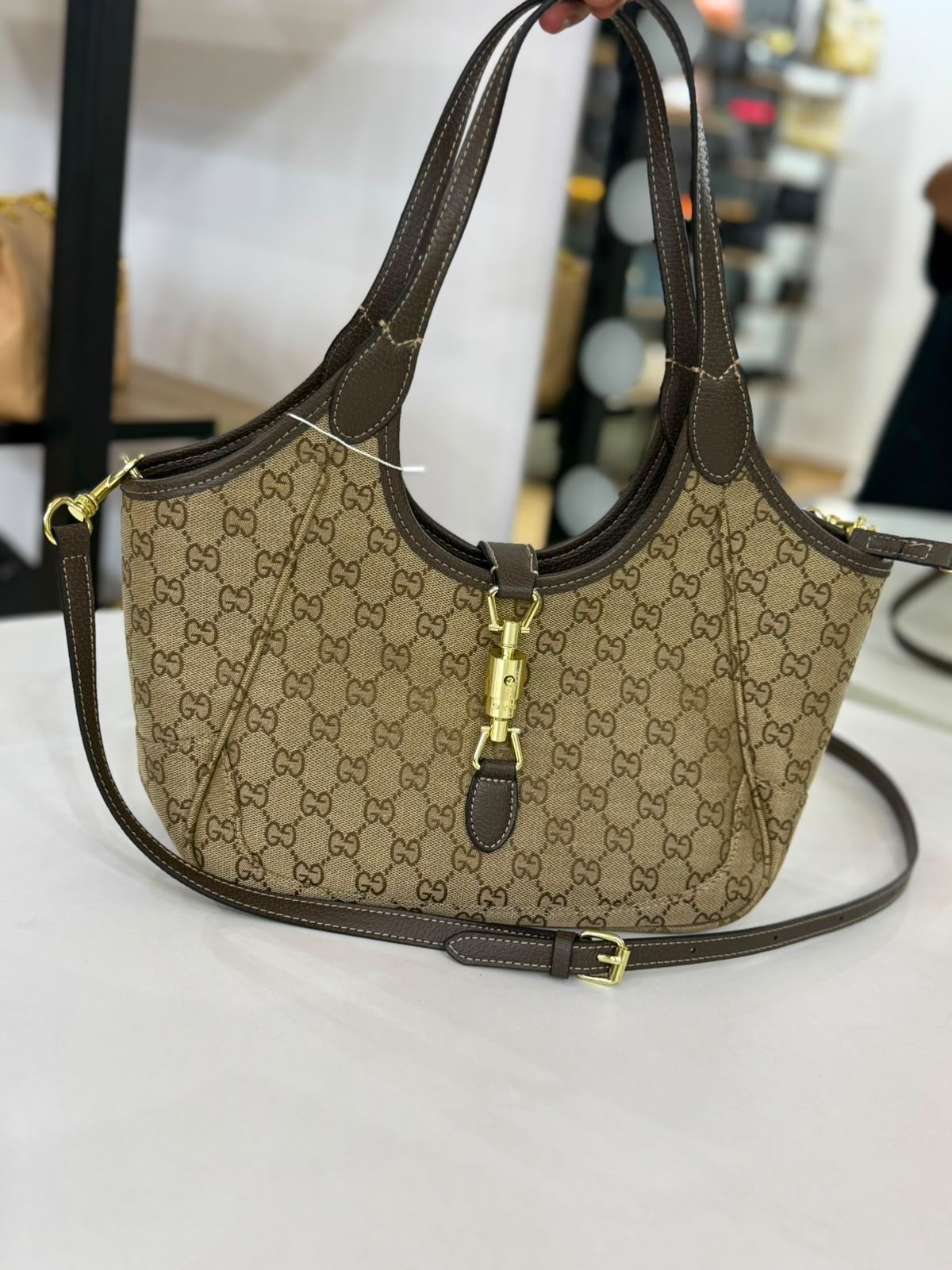 Gucci Mercato medium Tote Bag is crafted from monogrammed GG canvas with dark brown leather trim