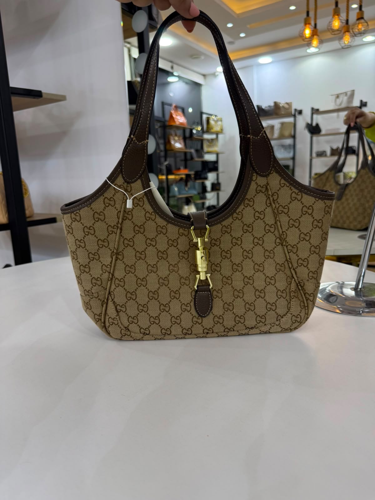 Gucci Mercato medium Tote Bag is crafted from monogrammed GG canvas with dark brown leather trim