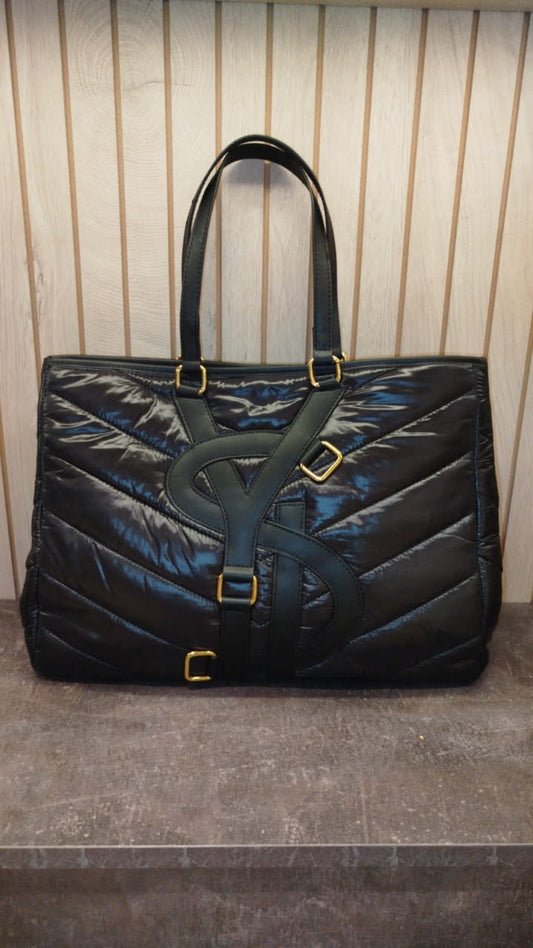 YSL tote bag features a black quilted design with gold-tone hardware.