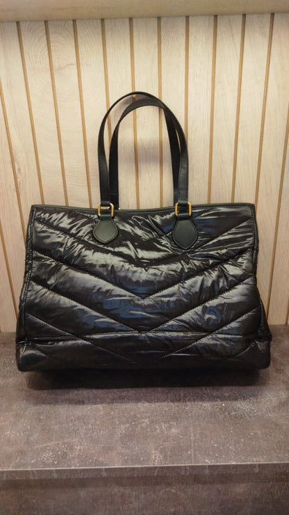 YSL tote bag features a black quilted design with gold-tone hardware.