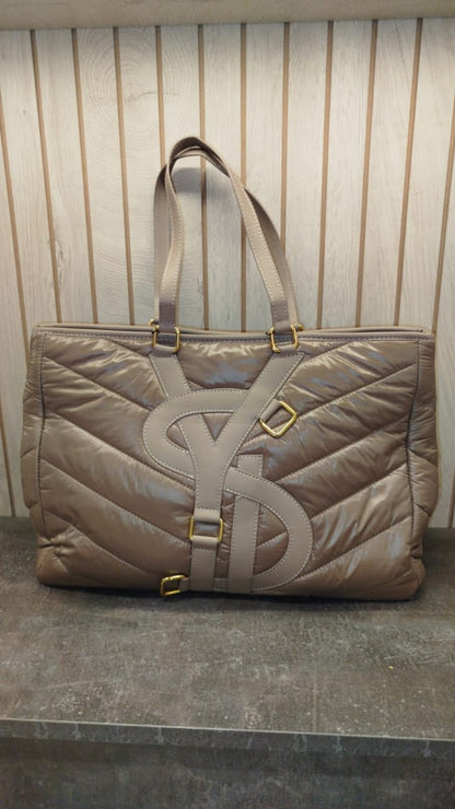 YSL tote bag, features a quilted, nylon puffer design in a taupe color with prominent YSL branding.