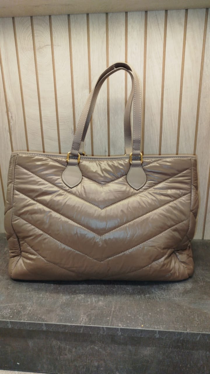 YSL tote bag, features a quilted, nylon puffer design in a taupe color with prominent YSL branding.